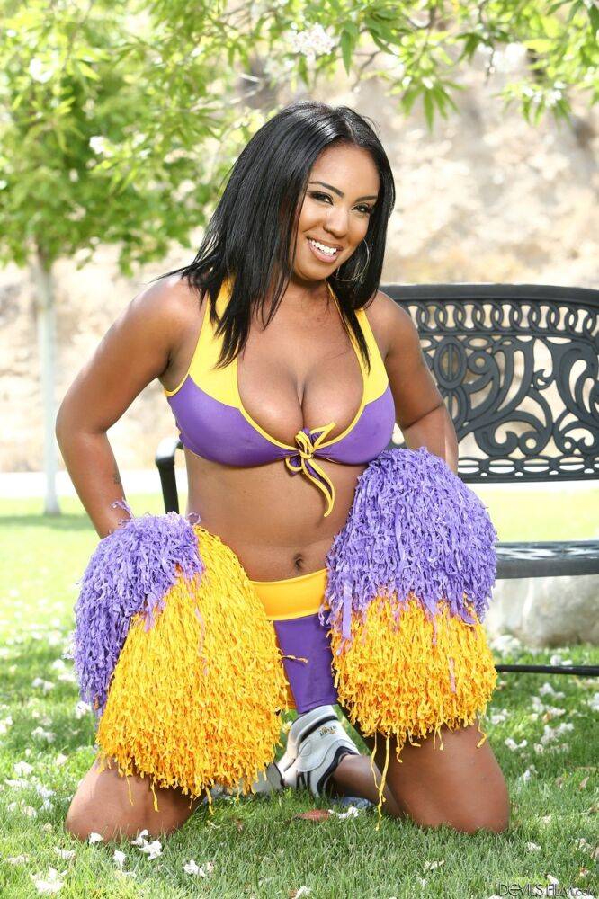 Phat cheerleader Layton Benton showing off her big natural pom poms in garden - #2