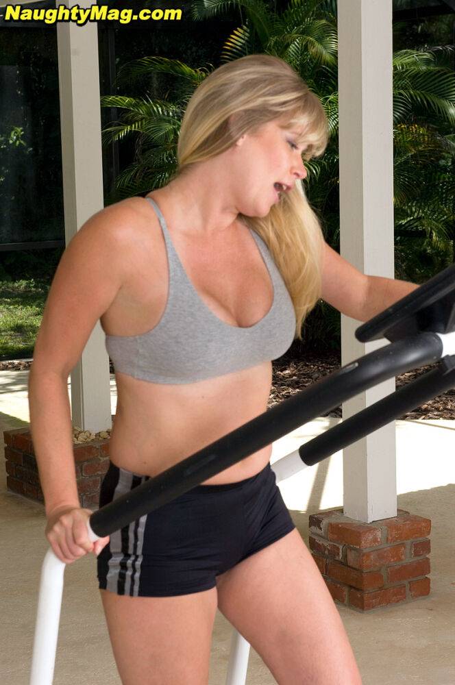 Busty blonde MILF exposes her big natural tits while working out at the gym - #14
