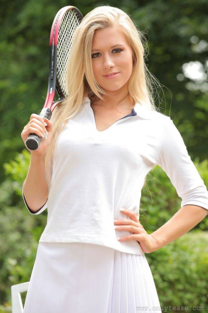 Natural blonde Michelle Moist doffs tennis attire to pose nude on a patio - #2