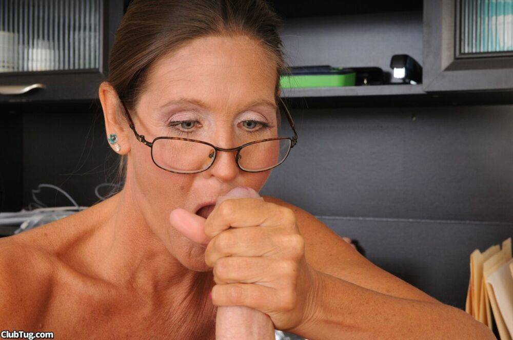 Sexy glasses clad MILF gives hot big cock handjob while sitting at her desk - #10