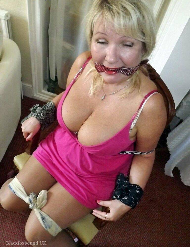 Mature lady with blonde hair ha her big naturals exposed after being tied up - #2