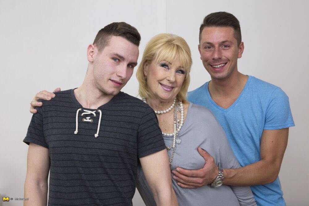 Blonde mature woman gets two boy toys to suck her big tits in old young 3some - #11