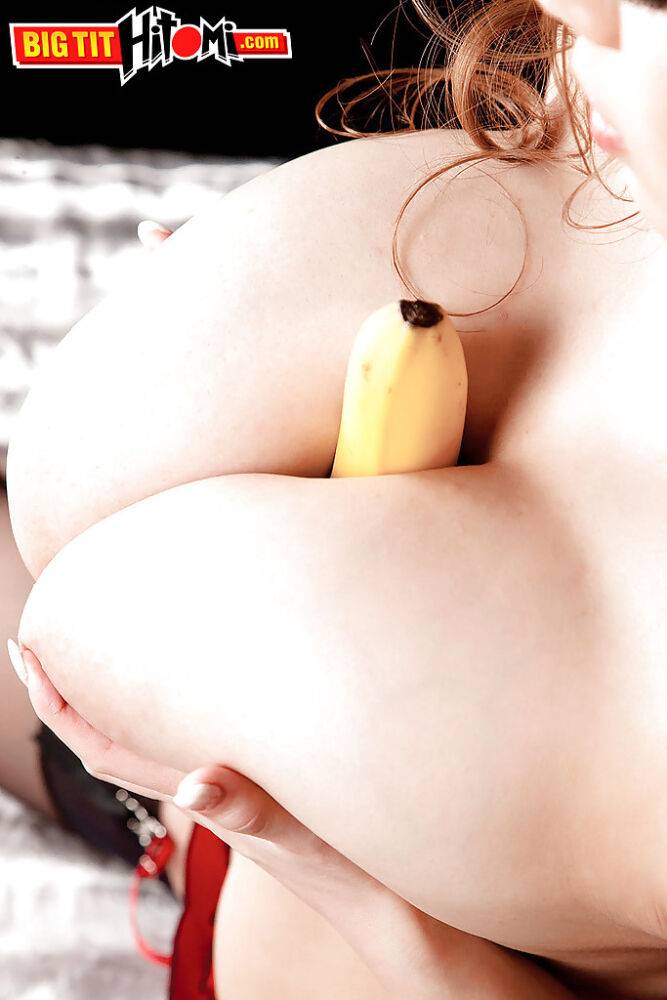 Asian babe Hitomi showing off huge hanging teen tits while eating banana - #2