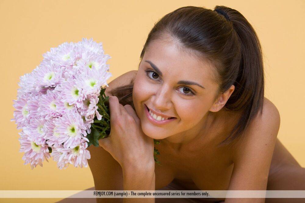 Pretty girl Alannis holds bunches of flowers while modelling in the nude - #15