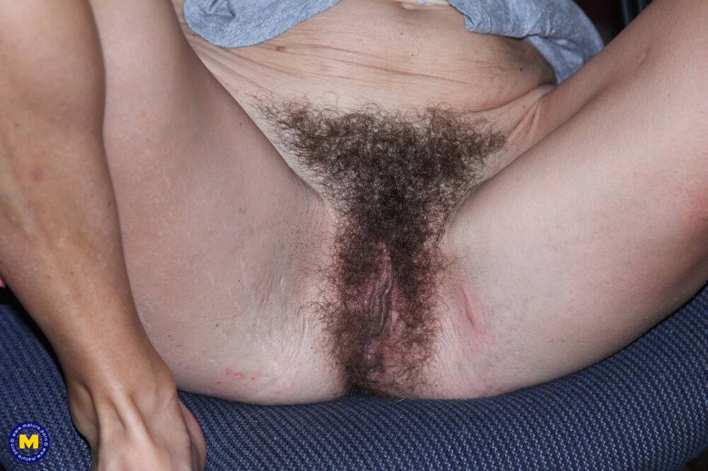 Slender woman puts her hairy pussy on display under an awning - #10