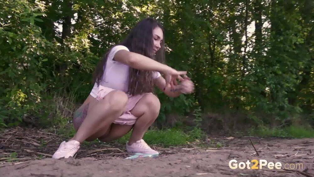 Brunette girl Sasha S emerges from the woods to take a piss on a patch of dirt - #14