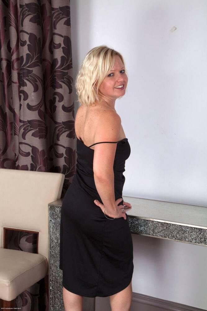 Middle aged blonde tugs on her labia lips after removing her black dress - #9