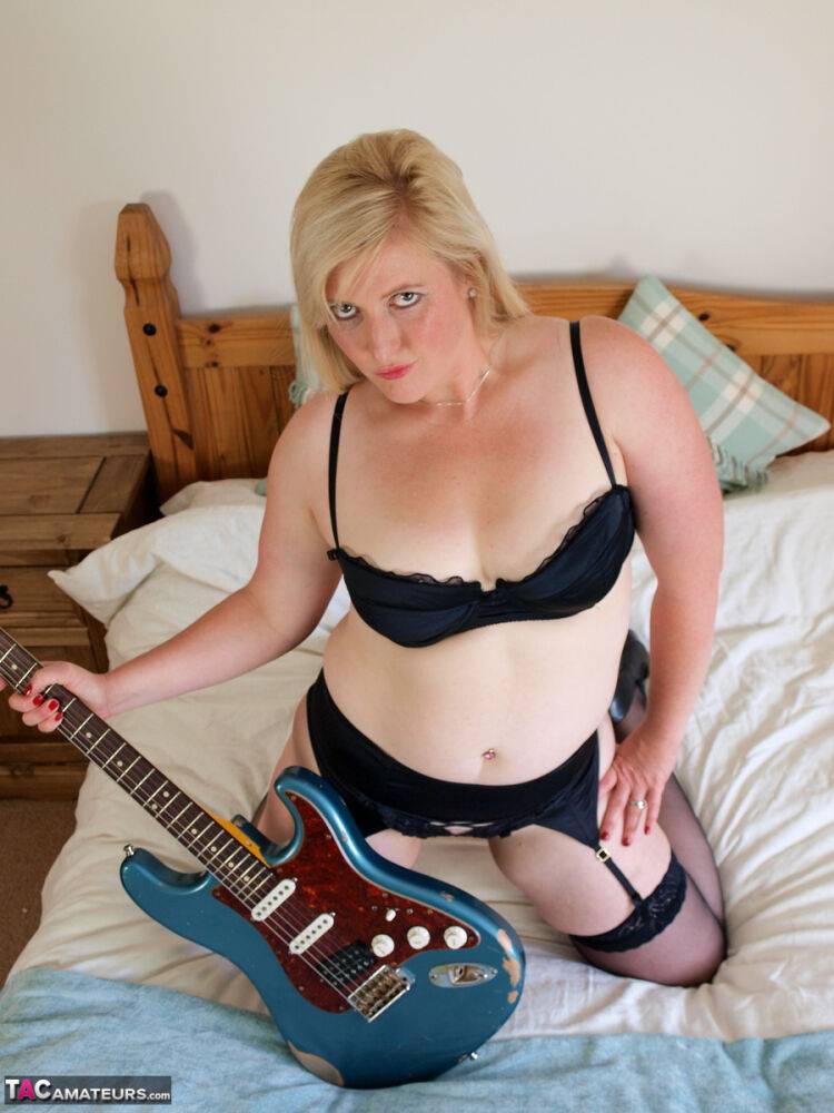 Chubby blonde Samantha fingers her pussy while holding an electric guitar - #7