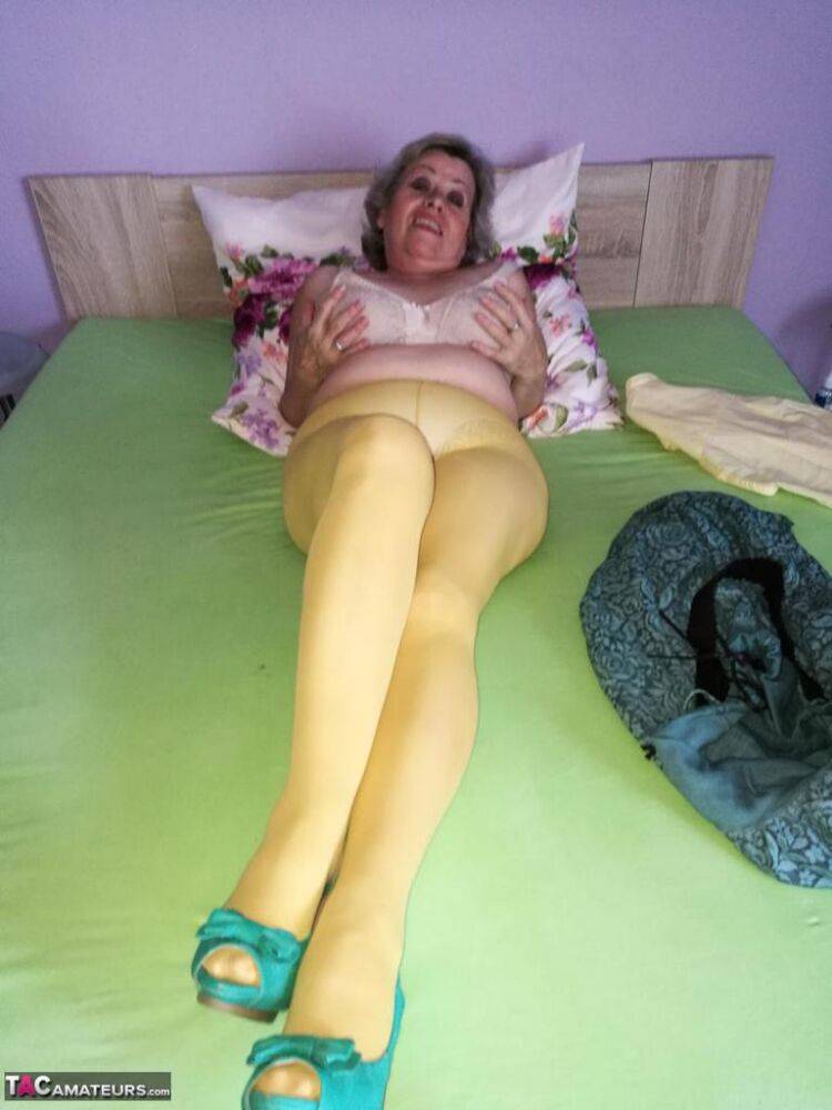 Old woman Caro releases her hairy vagina from yellow pantyhose on her bed - #15