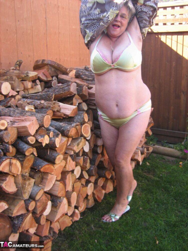 Brazen older granny strips off by the wood pile to show off BBW tits & big ass - #13