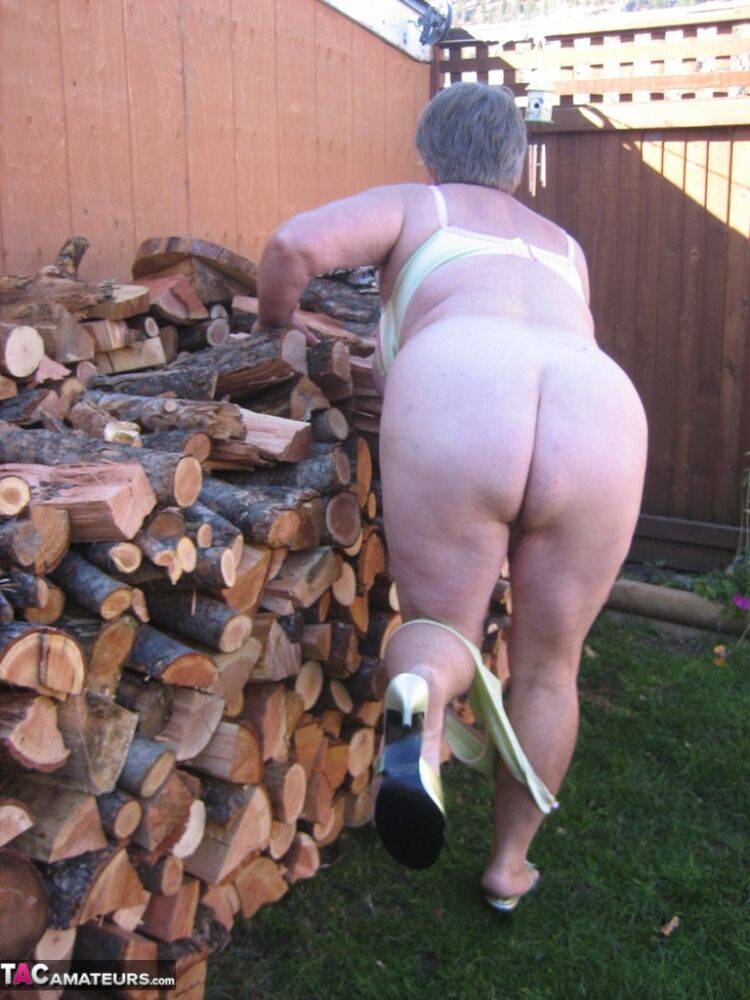 Brazen older granny strips off by the wood pile to show off BBW tits & big ass - #16