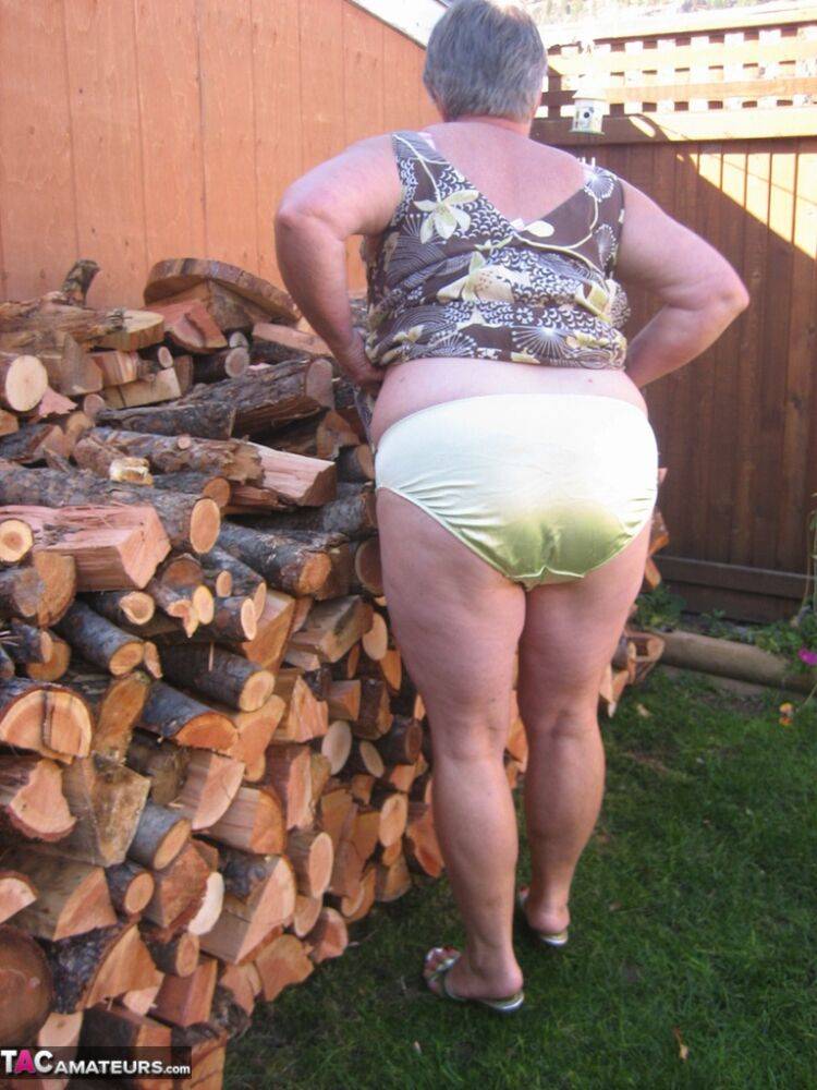 Brazen older granny strips off by the wood pile to show off BBW tits & big ass - #1