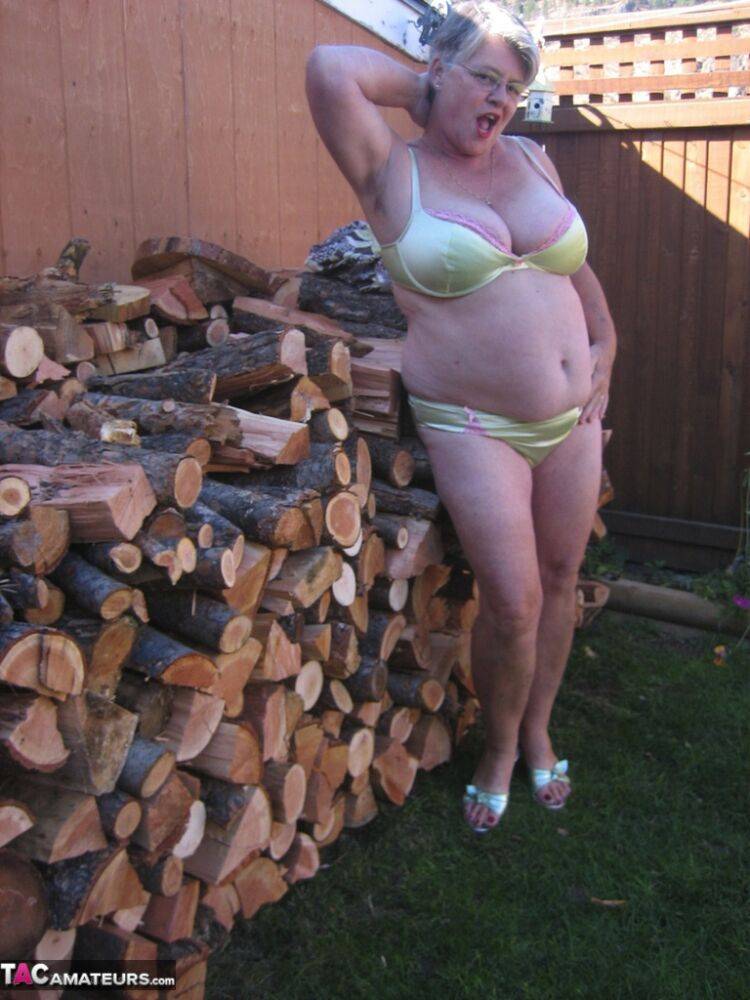 Brazen older granny strips off by the wood pile to show off BBW tits & big ass - #11