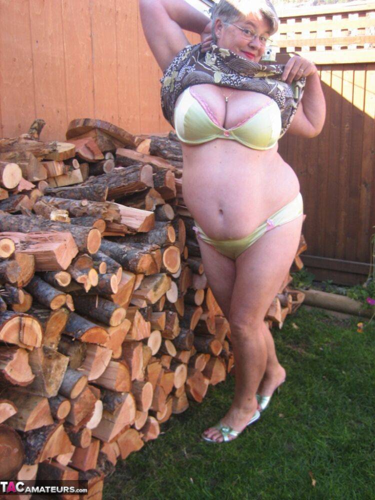 Brazen older granny strips off by the wood pile to show off BBW tits & big ass - #2