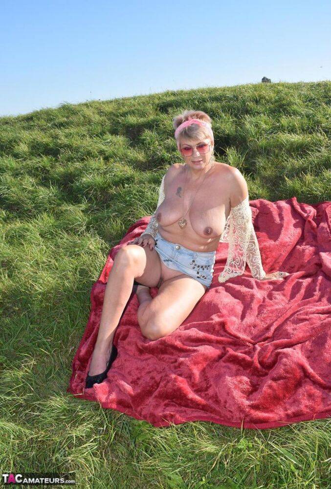 Older amateur Dimonty shows her natural tits and pussy on a blanket in a field - #13