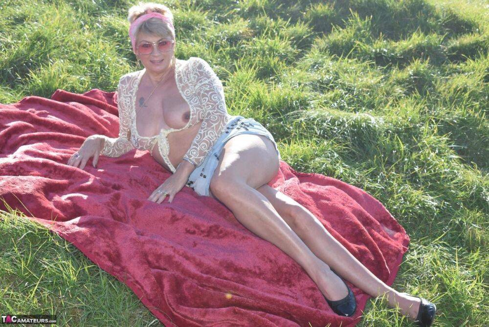 Older amateur Dimonty shows her natural tits and pussy on a blanket in a field - #15