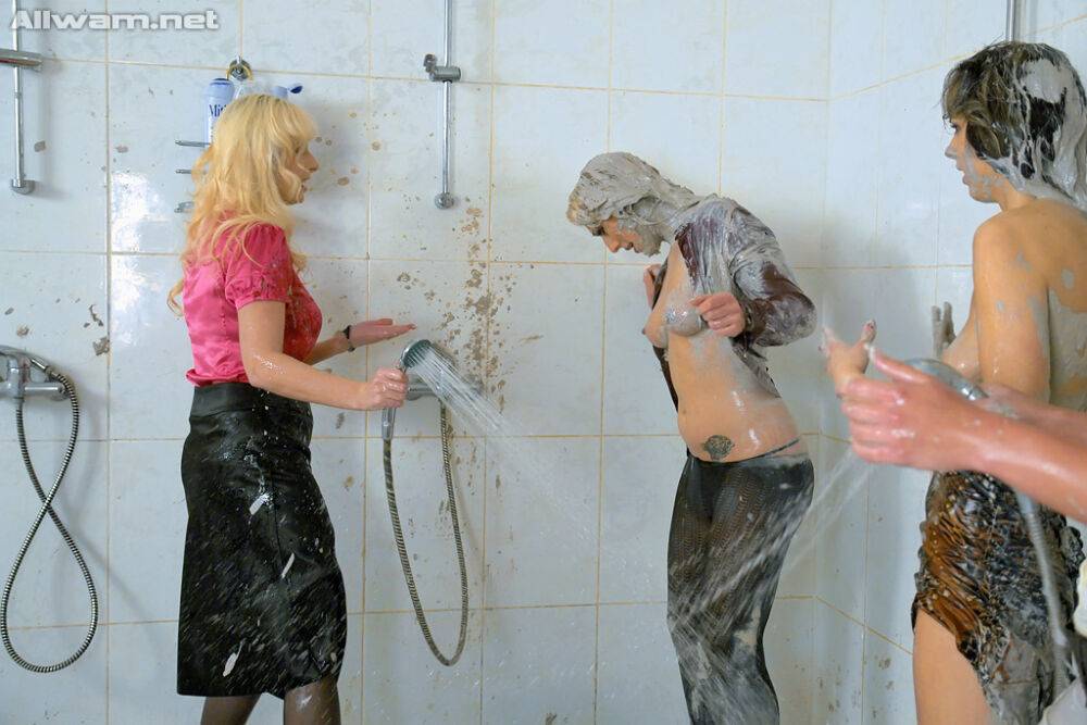 Fully clothed fetish fashionistas taking a shower together - #1