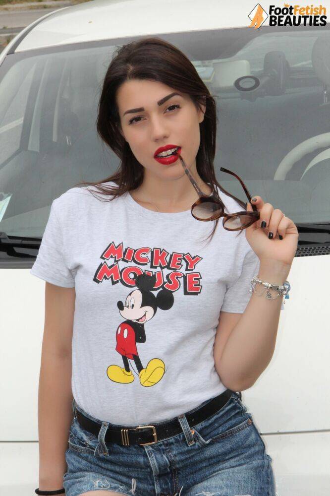 Hot girl displays her sexy feet in a car while wearing a Mickey Mouse T-shirt - #4