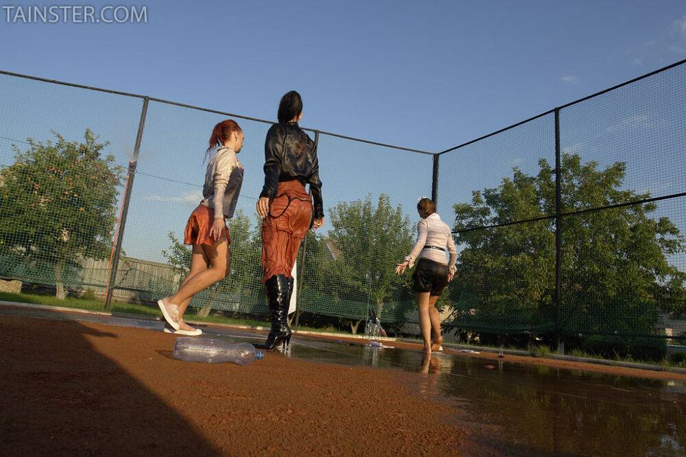 Seductive fully clothed fetish babes having some wet fun outdoor - #5