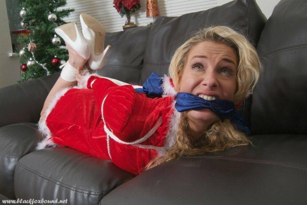 Blonde chick Katie C is cleave gagged and hogtied in Christmas attire - #3