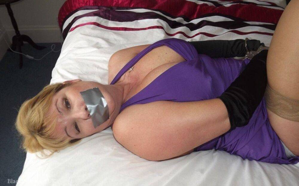 Busty older blonde is left tied up and gagged in numerous outfits - #14