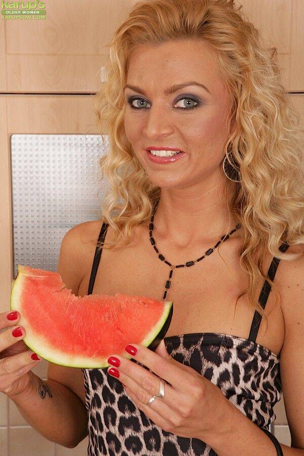 Blonde female Sophia Magic takes a bite of watermelon before disrobing at home - #7