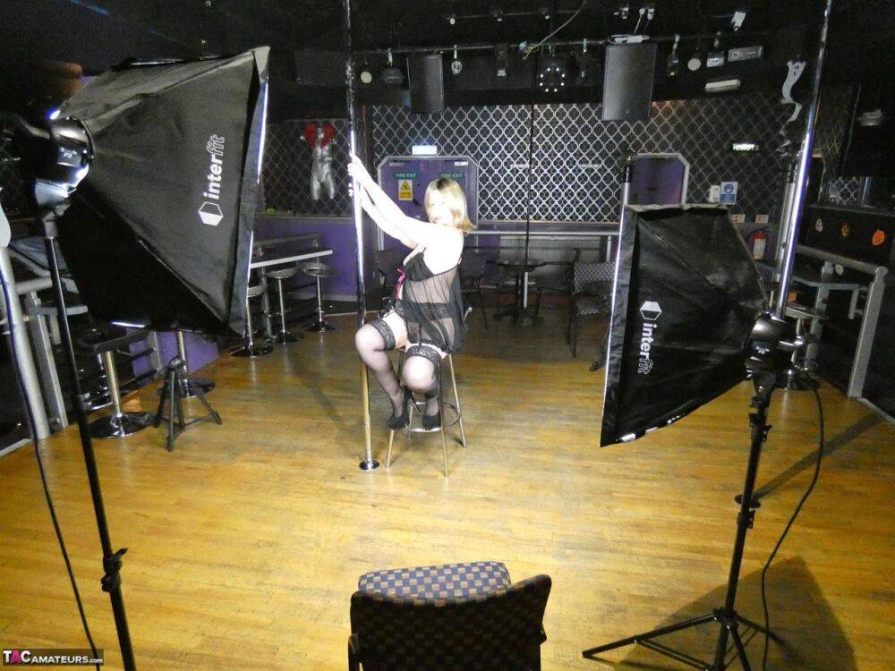 Older amateur Posh Sophia works a stripper pole inside an empty club - #1