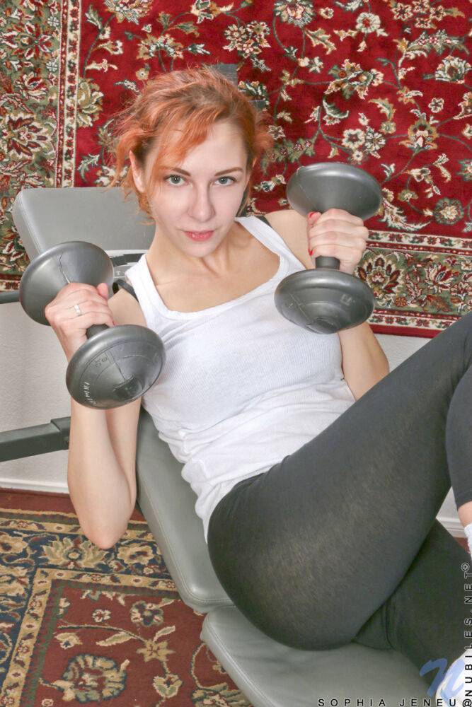 Natural redhead Sophia Jeneu pumps iron before getting naked on a trampoline - #13