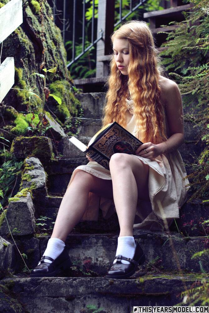 Young redhead Dolly Little exposes herself on garden steps while reading - #2