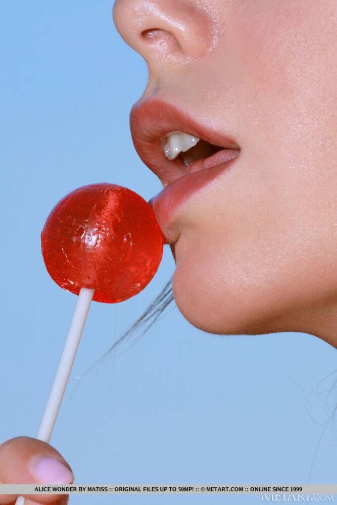Alice Wonder flirtatiously enjoys the red big lollipop as she takes off her - #14