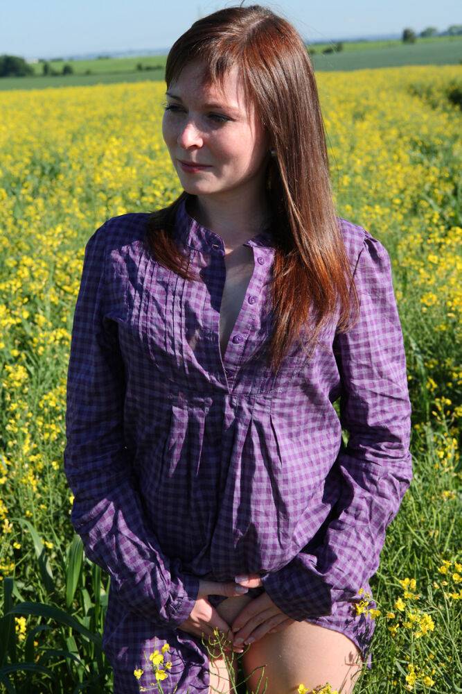 Young redhead gets completely naked in a field of Rapeseed - #13