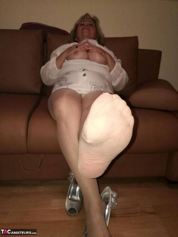 Mature lady exposes her large tits while having a smoke in pantyhose - #8