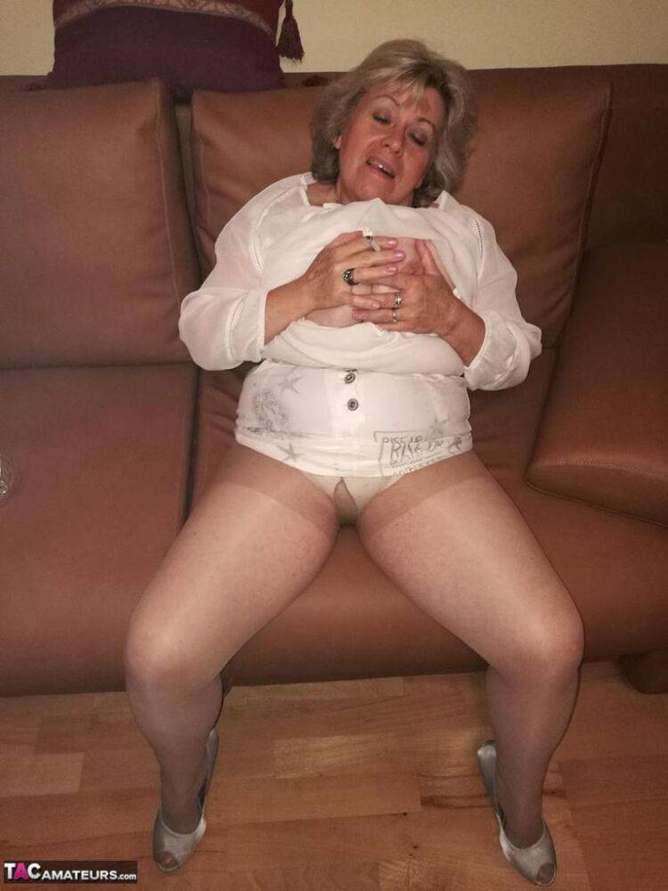 Mature lady exposes her large tits while having a smoke in pantyhose - #4