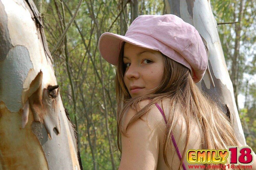 Adorable young girl shows her ass crack during a tease shoot in the woods - #13