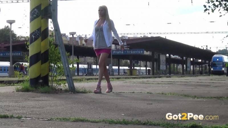 Pretty blonde pees on a train platform - #1