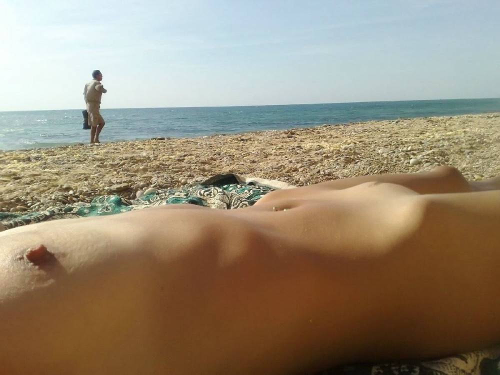 Naked teens play together at a public beach - #7