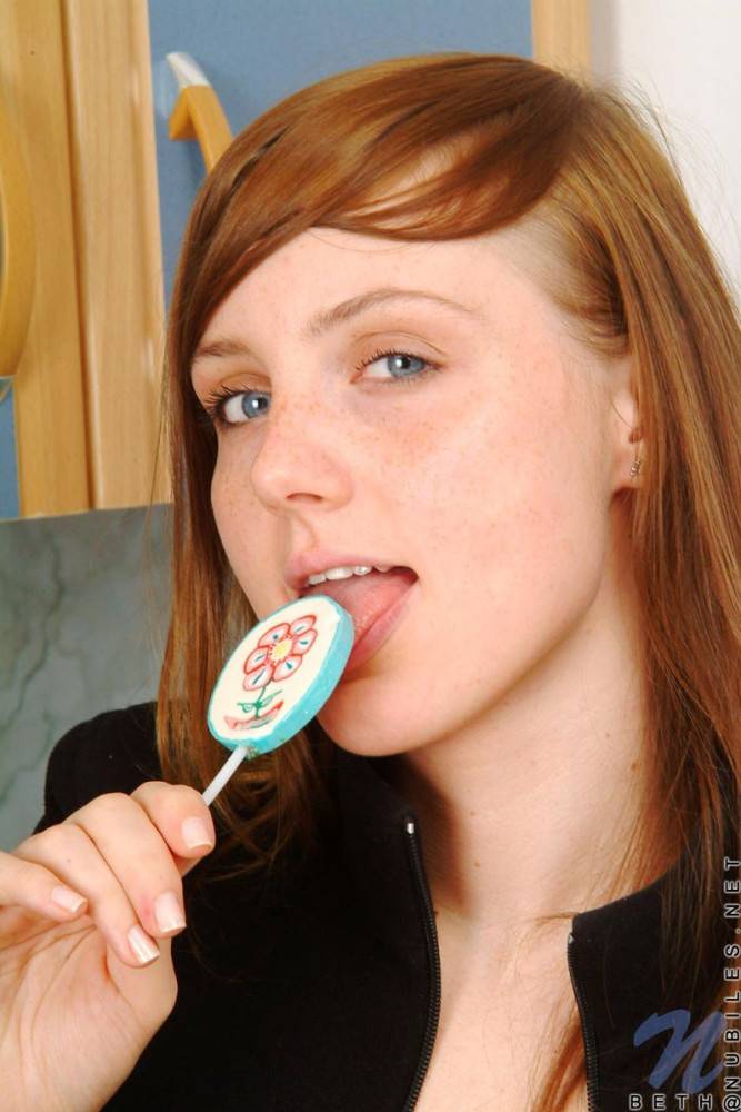 Red Haired Teen Babe Beth Nubiles Slowly Strips While Eating A Lollipop. - #7