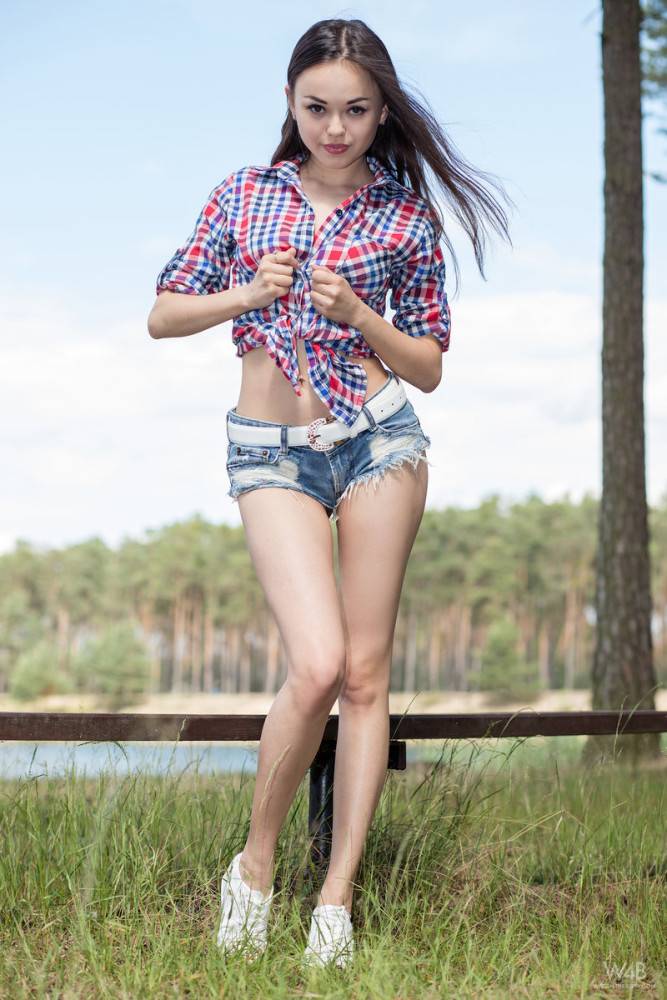 Rangy ukrainian dark-haired teen Li Moon in shorts shows big titties and spreads her legs outdoor - #4