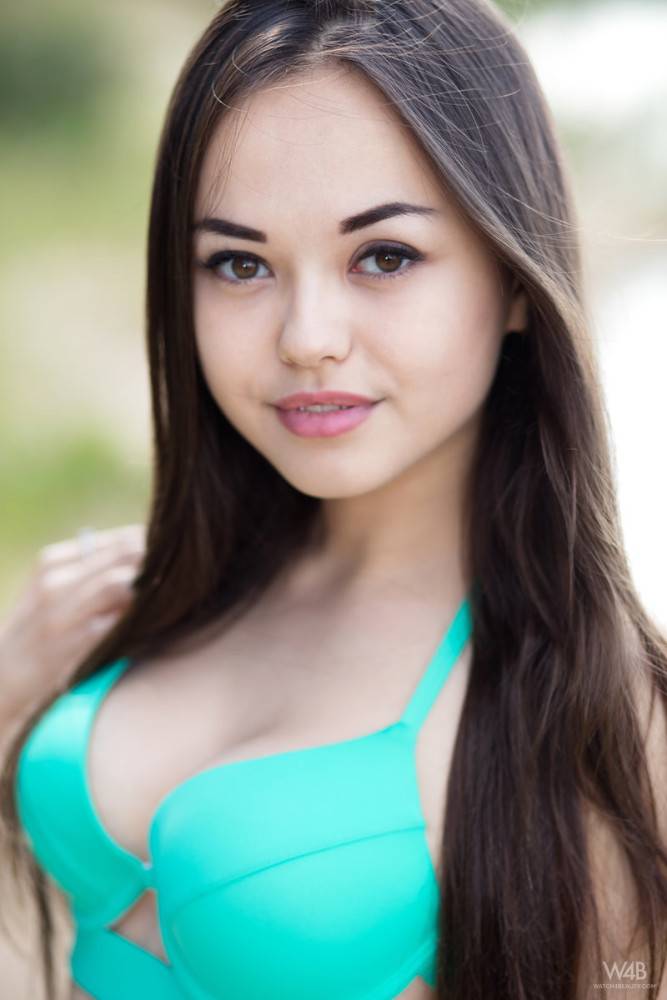 Very attractive ukrainian brunette teen Li Moon in bikini exhibiting big tits and spreading her legs at beach - #2