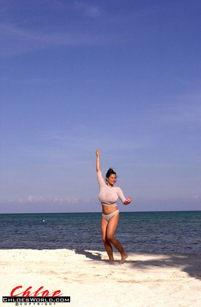 Seductive german dark-haired milf Chloe Vevrier in beautiful bikini shows big tits and spreads her legs on the beach | Photo: 7985511