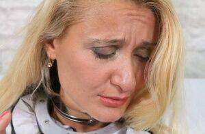 Blonde female is restrained by cuffs on neck and wrist as well as thumbs on pornstar6.com