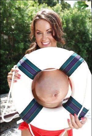 Big tit model Sarah Nicola Randall flaunting her oiled juggs outdoors on pornstar6.com