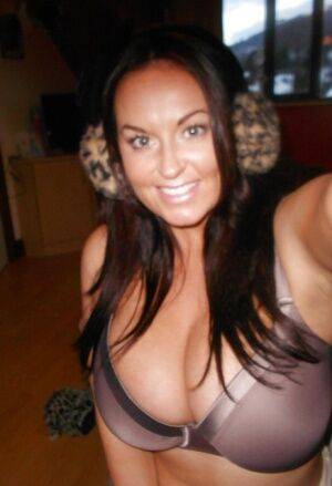 Buxom brunette babe Sarah Nicole Randall posing topless with ear muffs on pornstar6.com