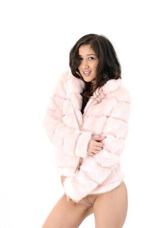 Brunette teen Darcia Lee doffs a fur coat and leggings before dildo riding on pornstar6.com