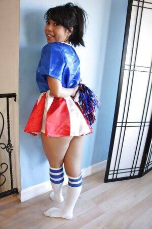 Tiny Asian cheerleader May Lee posing in cute uniform and socks on pornstar6.com
