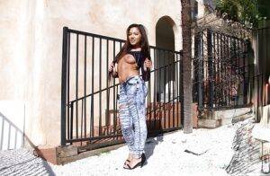 Amateur Asian teen babe Morgan Lee posing in denim jeans outdoors on pornstar6.com