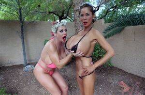 Big titted older women Claudia Marie and Minka kiss outdoors in skimpy bikinis on pornstar6.com