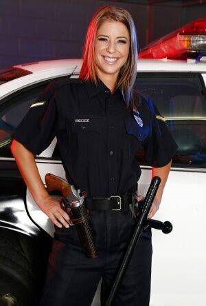 Sassy hottie in police uniform undressing and spreading her legs on pornstar6.com