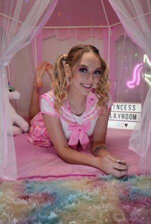 Cute teen Lily Larimar plays with her curly pigtails while getting naked on pornstar6.com