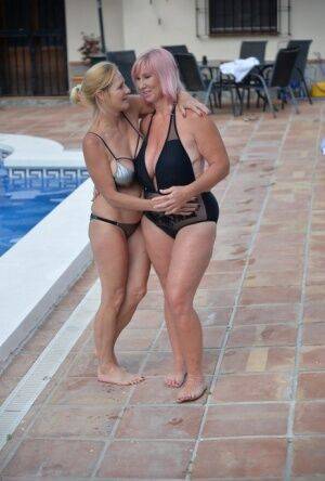 Mature amateurs share a lesbian kiss in their swimwear on poolside patio on pornstar6.com